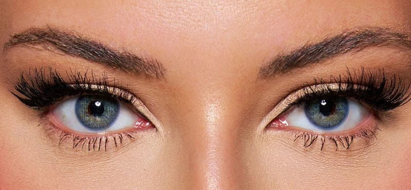 Front view of a model wearing natural Blue colored contact lenses paired with dramatic lashes and soft glam makeup – a bold, mesmerizing look by KIISBEAUTY.