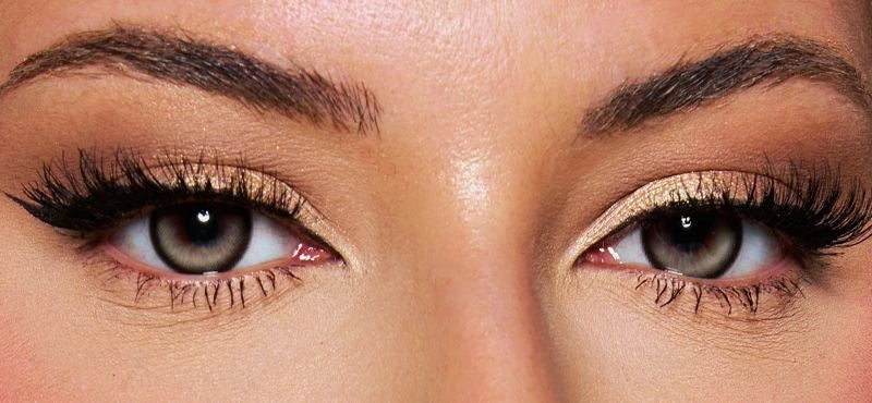 Front view of a model wearing icy grey colored contact lenses paired with dramatic lashes and soft glam makeup – a bold, mesmerizing look by KIISBEAUTY.