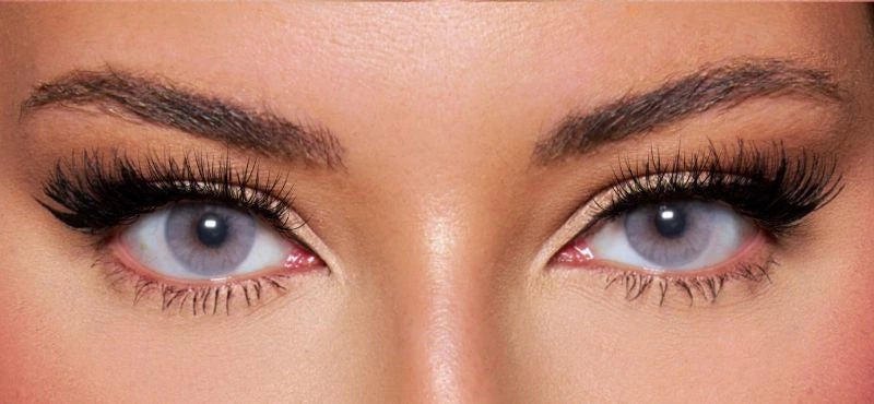 Front view of a model wearing natural greycolored contact lenses paired with dramatic lashes and soft glam makeup – a bold, mesmerizing look by KIISBEAUTY.